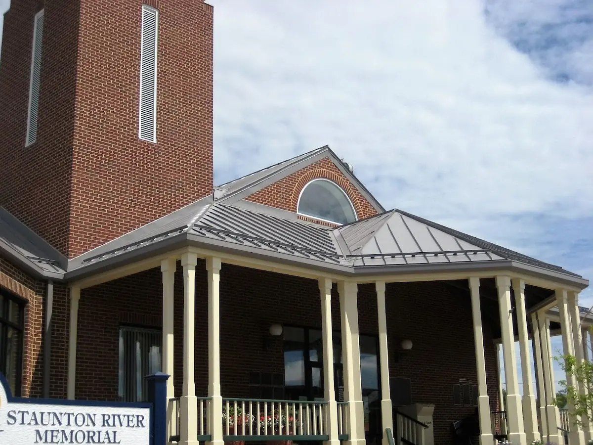 Skilled roofing craftsmen working on a residential roof in Raisinville